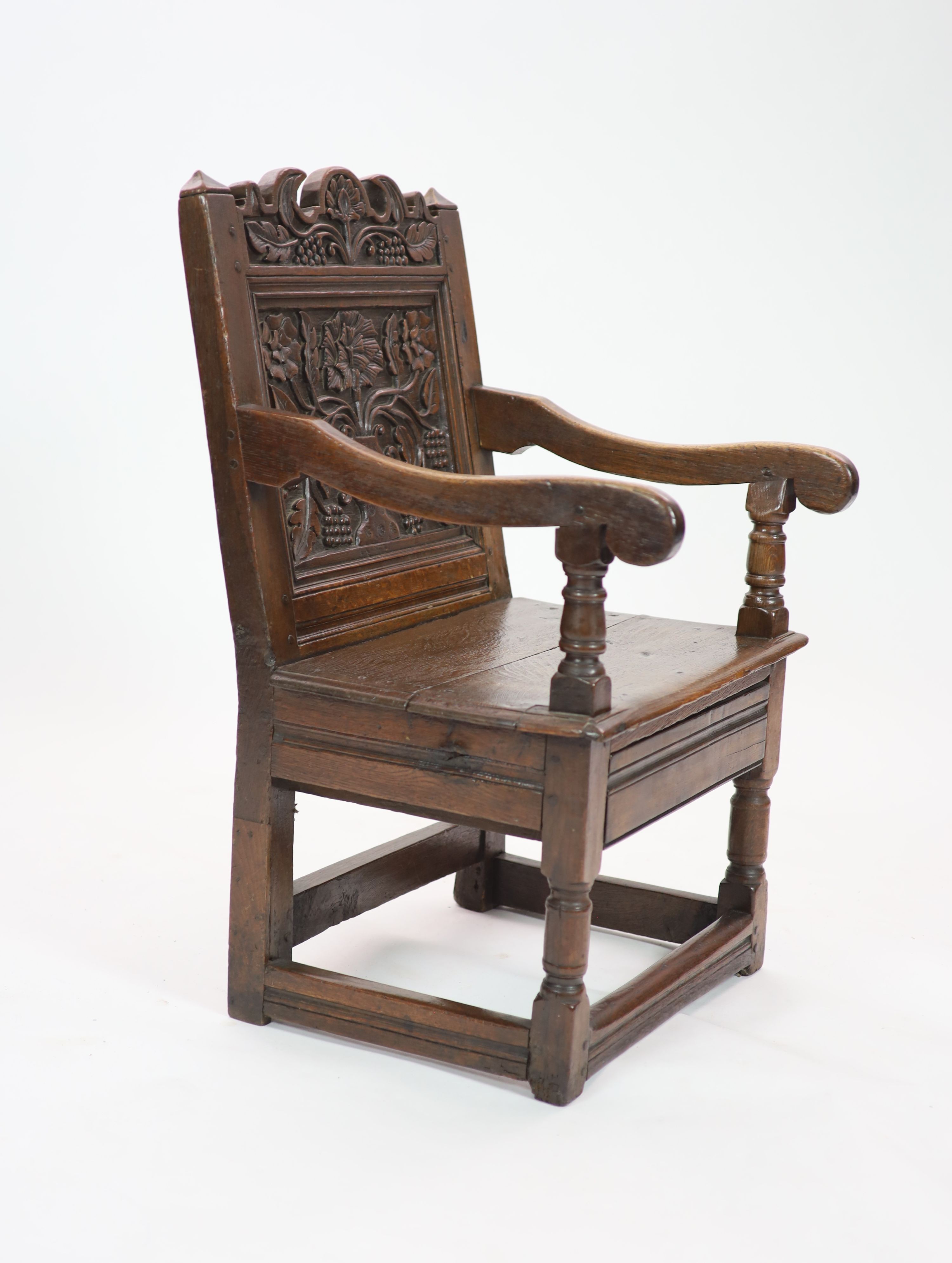 A South Lancashire/North Cheshire Charles II carved and panelled oak open armchair H 93cm. W 60cm. D 53cm.
